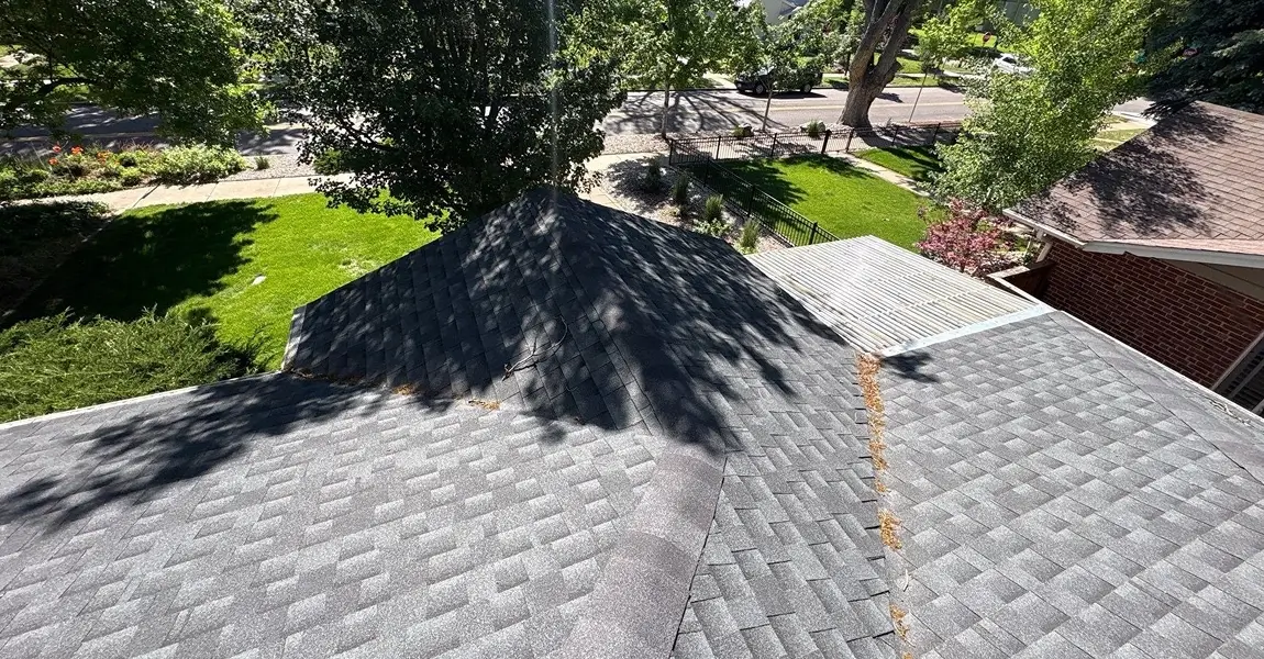 Colorado Springs homeowner preparing roof insurance claim documentation with contractor report and storm date notes